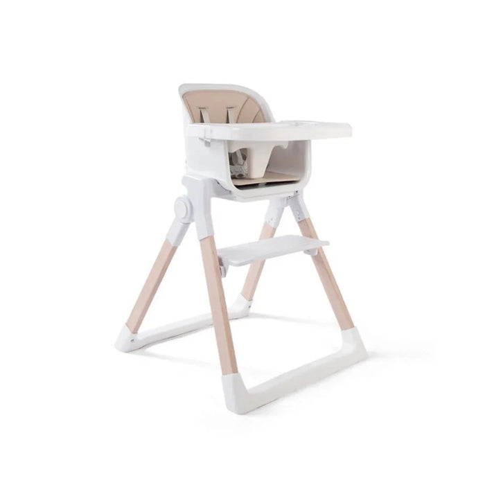 White baby highchair with beige seat, front tray, and 5-point harness