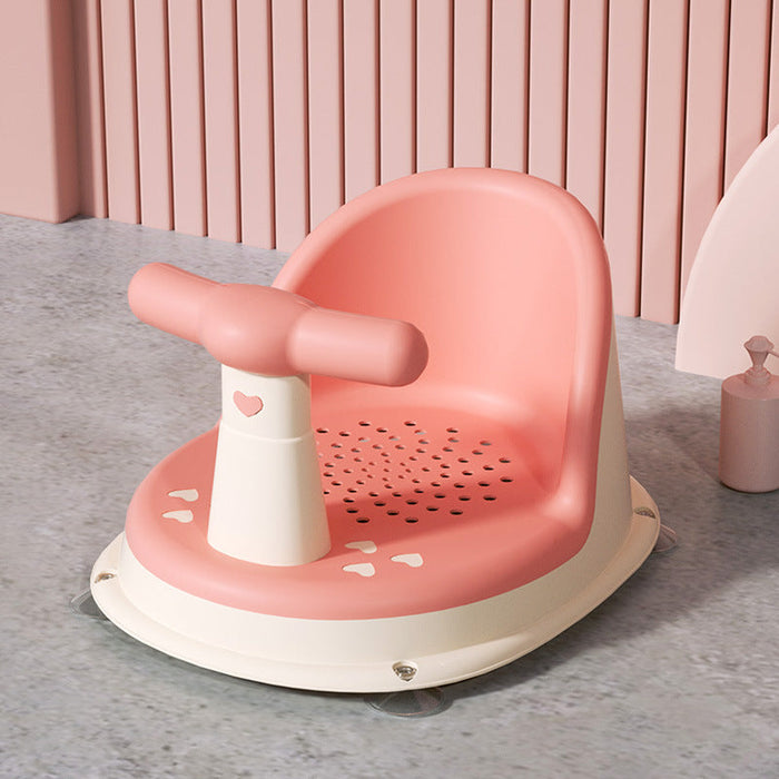 Baby bath seat with coral pink tub and white splash guard, perforated base support