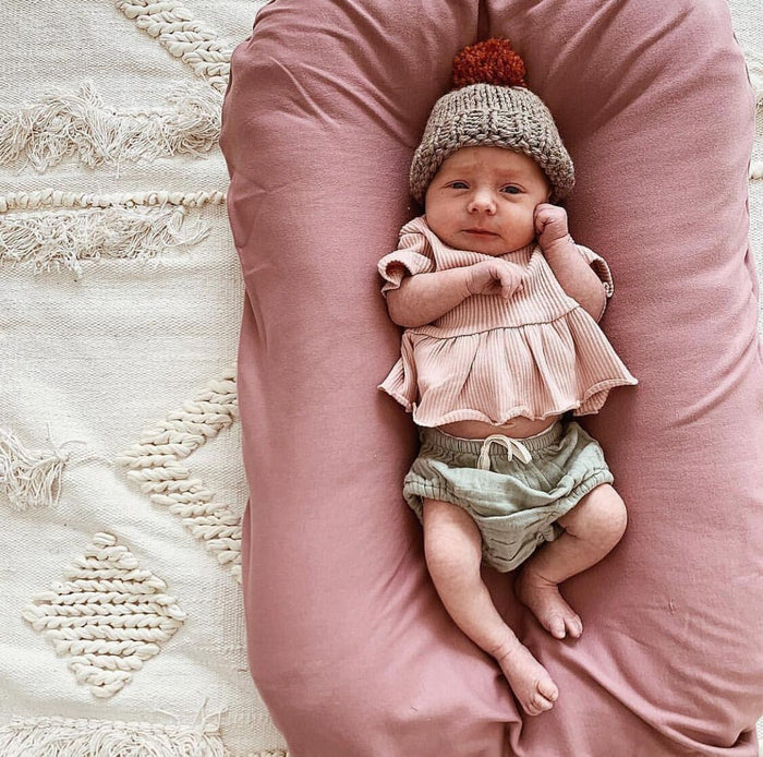 Newborn portable nest bed, mauve cradle cushion with baby