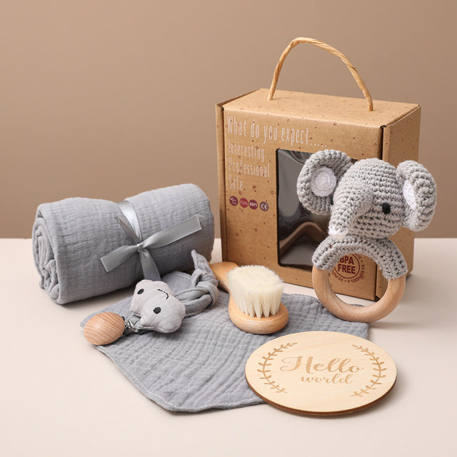 Gray elephant bath toy set with plush, wooden teether brush, muslin cloth, and tag disc.