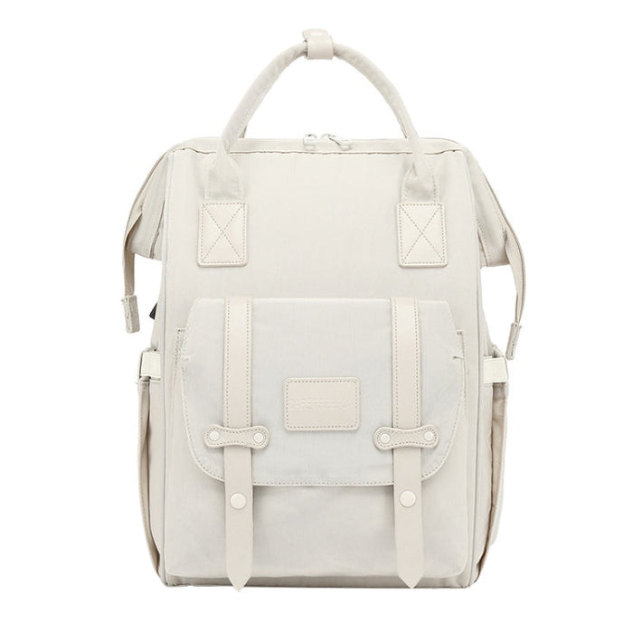 Large mommy backpack with front flap pockets and double buckle straps, light neutral color