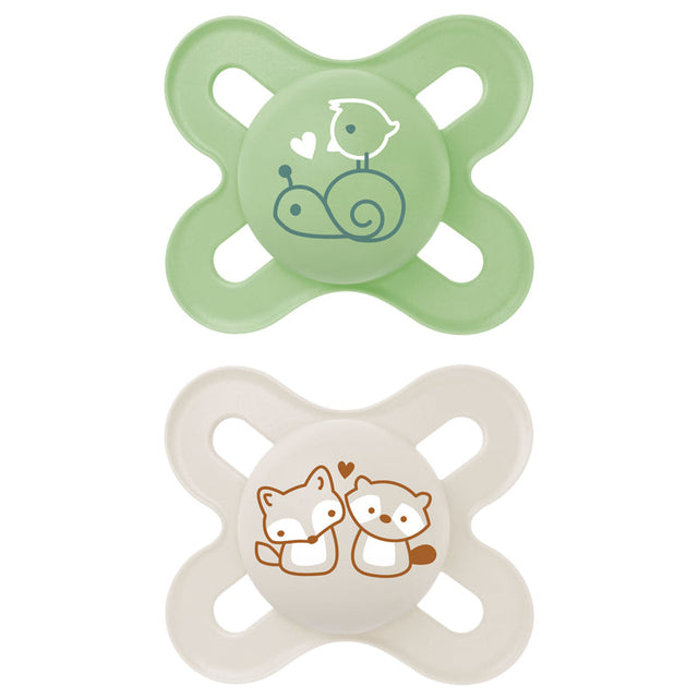 Pair of green and cream MAM baby soothers with animal designs