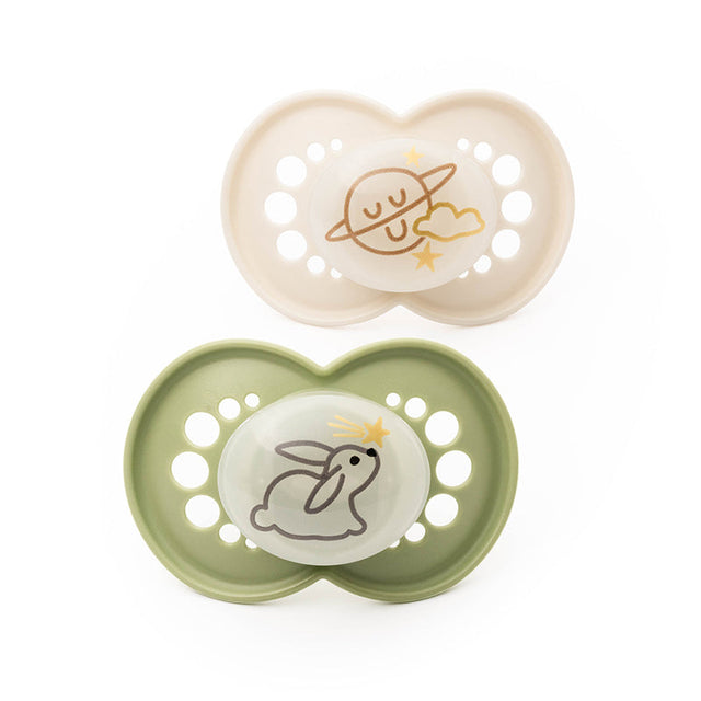 Two MAM night soothers with cream and green shields and sleeping animal designs.