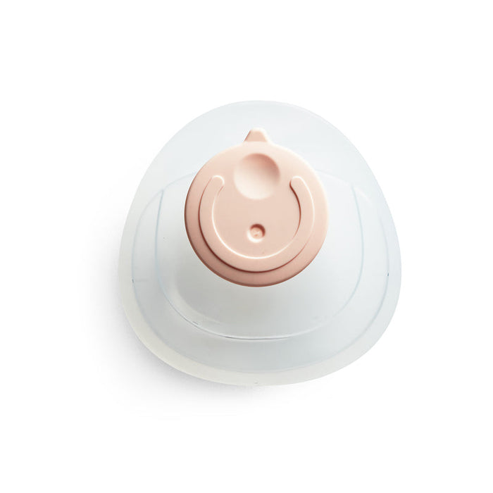 Silicone breastmilk collector cup with peach valve and white base