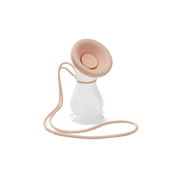 Silicone manual breast pump with beige top, white body, and lanyard tube