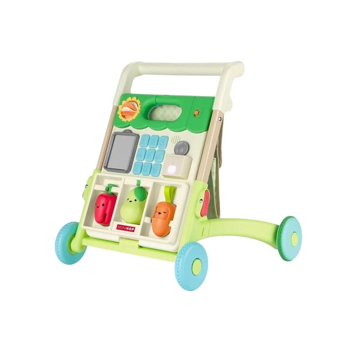 Green activity walker with push handle, front toy panel, wheels, and produce pieces