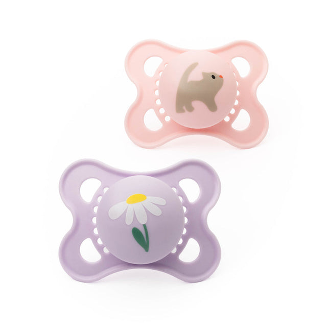 Two MAM Original soothers, one pink with an animal motif and one lavender with a daisy.