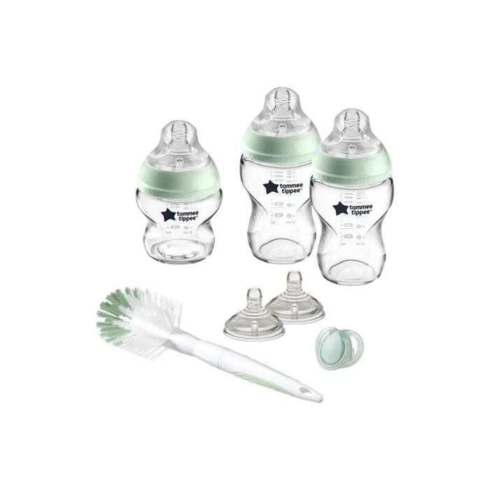 Glass baby bottle starter kit: three green teats, lids, and cleaning brush