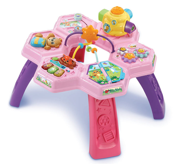 Pink activity table with purple legs, Busy Bee toys, and colorful interactive panels