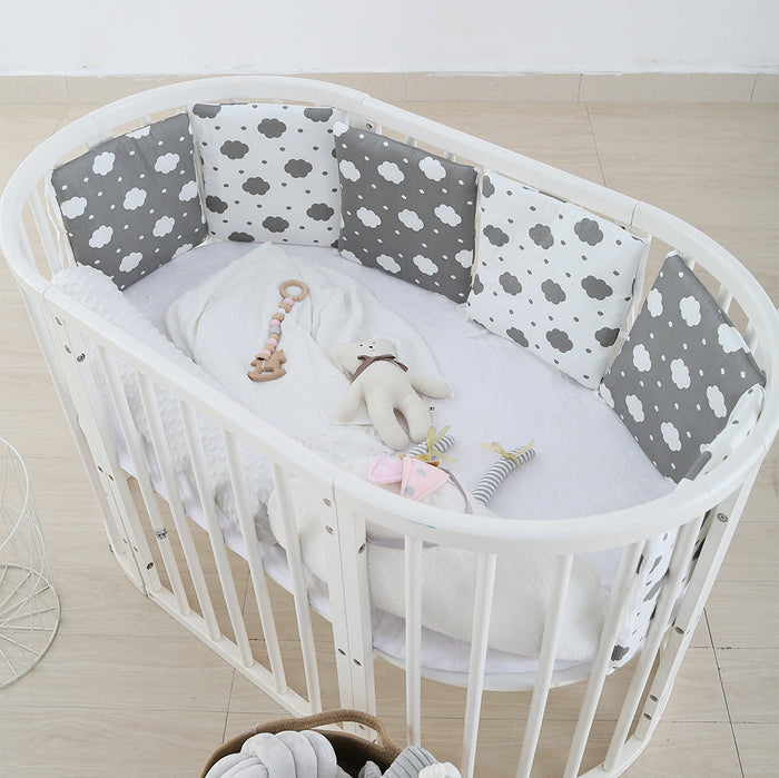 Cot bed anti-collision bumper set with white rails and gray cloud-pattern pads
