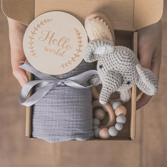 Baby bath gift set box with gray washcloth, plush elephant, and wooden teether
