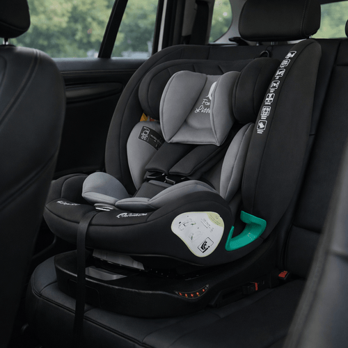 ISOFIX car seat in vehicle, dark gray seat with light gray cushions and green belt guide