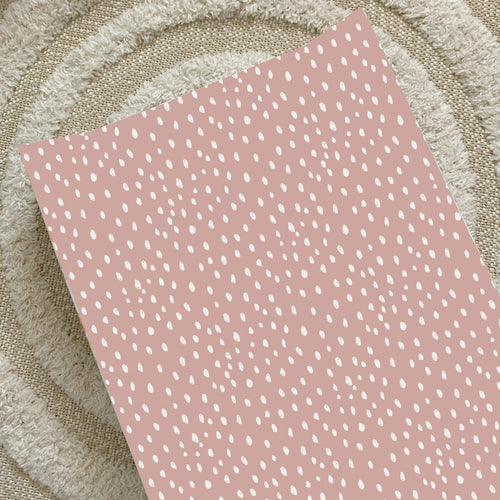 Dusky pink spotty anti-roll wedge changing mat with white speckle print