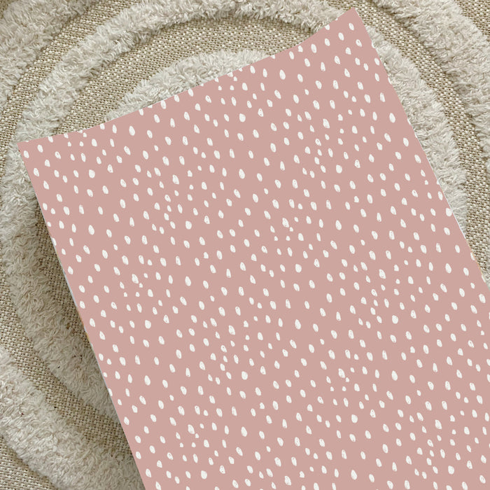 Dusky pink spotty anti-roll wedge changing mat with white speckle print