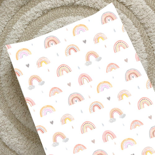 Wedge changing mat with rainbow pattern and small hearts on white fabric