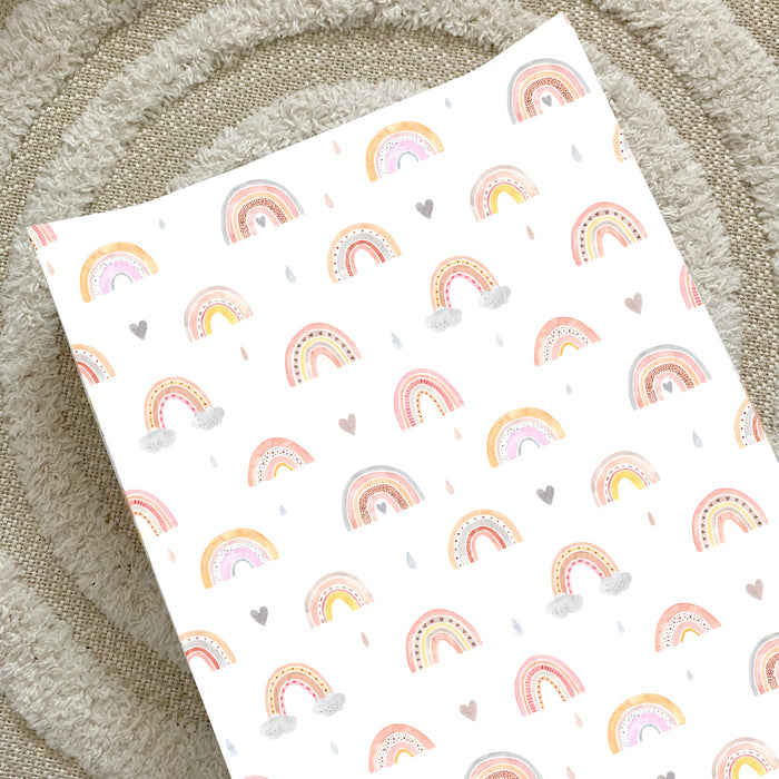 Wedge changing mat with rainbow pattern and small hearts on white fabric