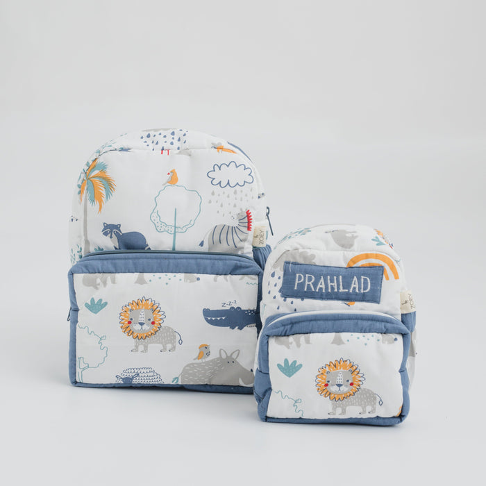 Kids fabric backpack with blue trim, safari animal print, front pocket and zips