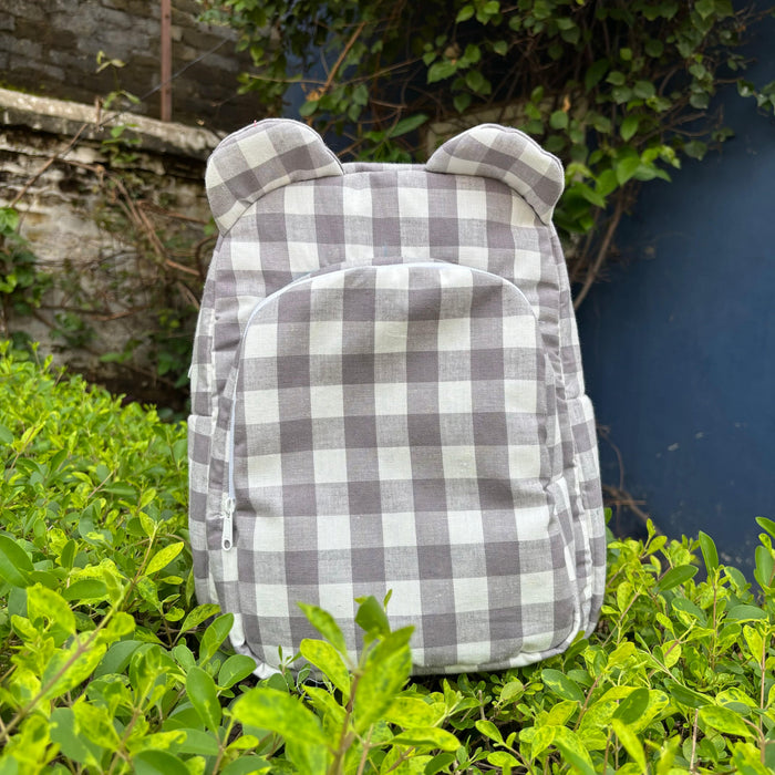 Grey checkered kids backpack with rounded ears and front zip pocket