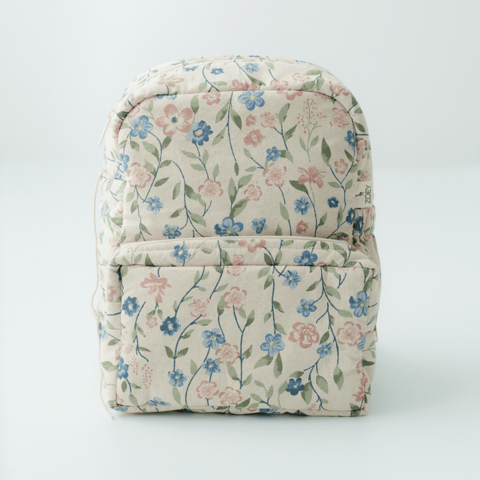 Kids backpack in floral fabric with front zip pocket and rounded top handle.