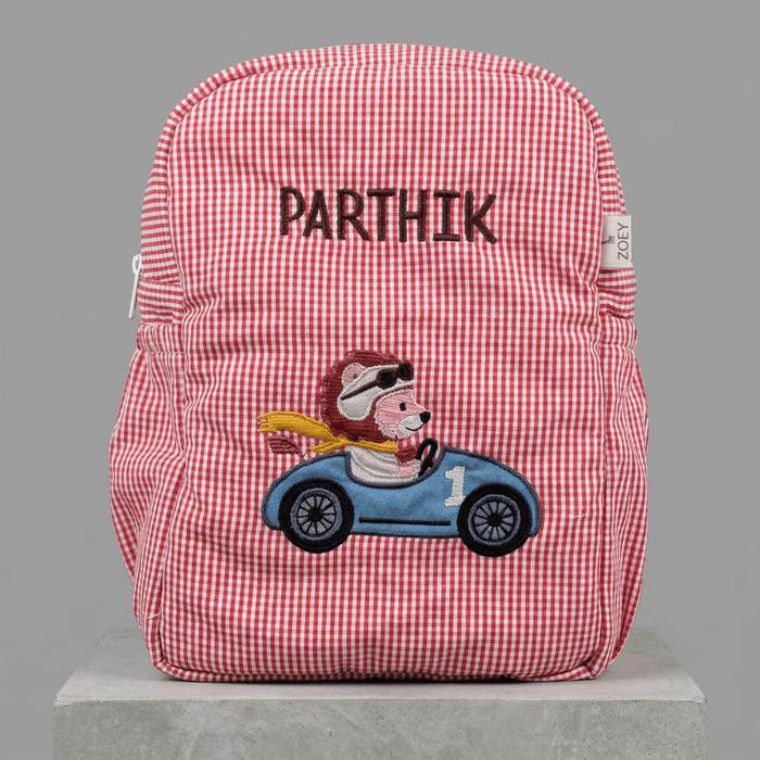 Kids backpack with red-and-white gingham fabric, front zip, and racing animal patch