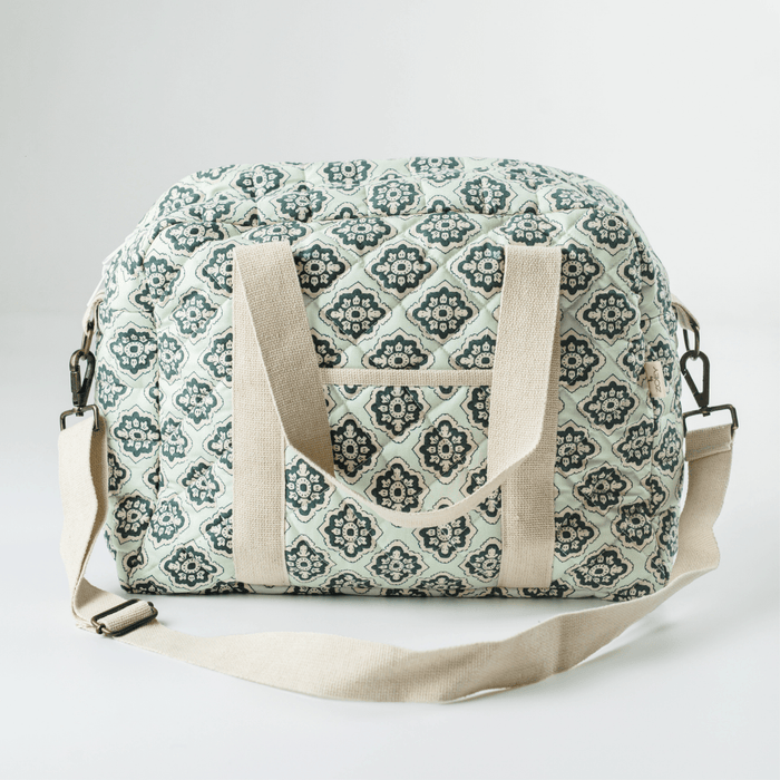 Cotton nappy bag with green trellis pattern, front pocket, dual fabric handles, shoulder strap