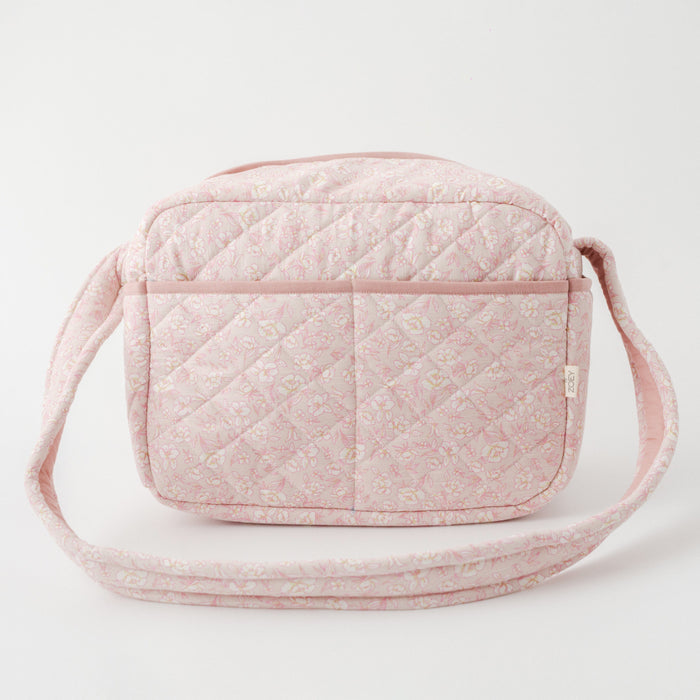 Pink floral quilted nappy bag with zip top and long carrying strap