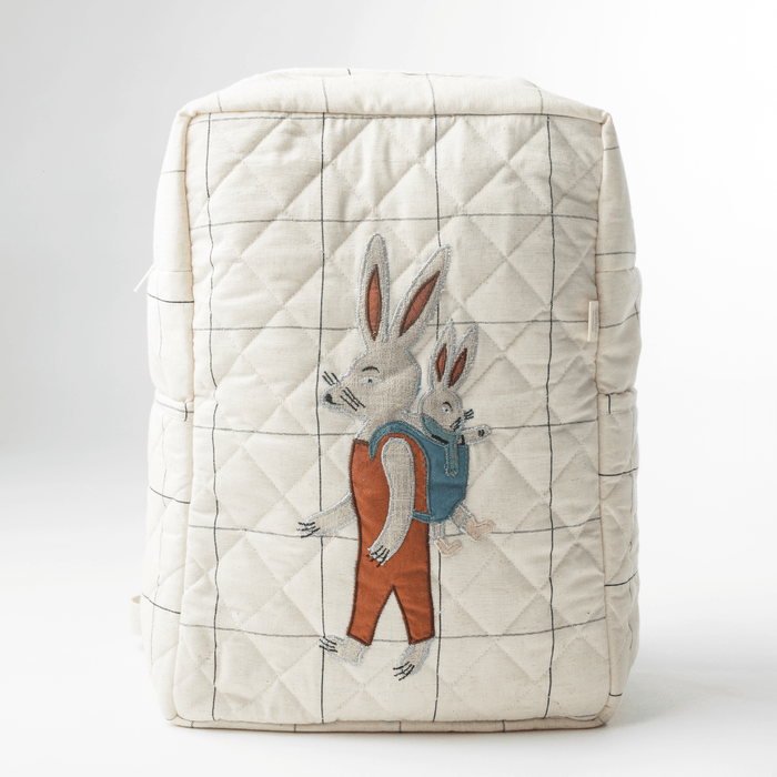 Quilted light cream nappy bag with bunny applique and grid stitching on front